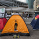 An Occupy Central protester looks her phone in her tent at a protest site in Admiralty near the government headquarters in Hong Kong October 16